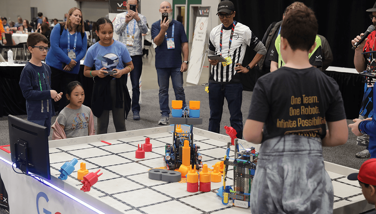 VEX IQ Competition with two teams competing on a field together with their two robots.